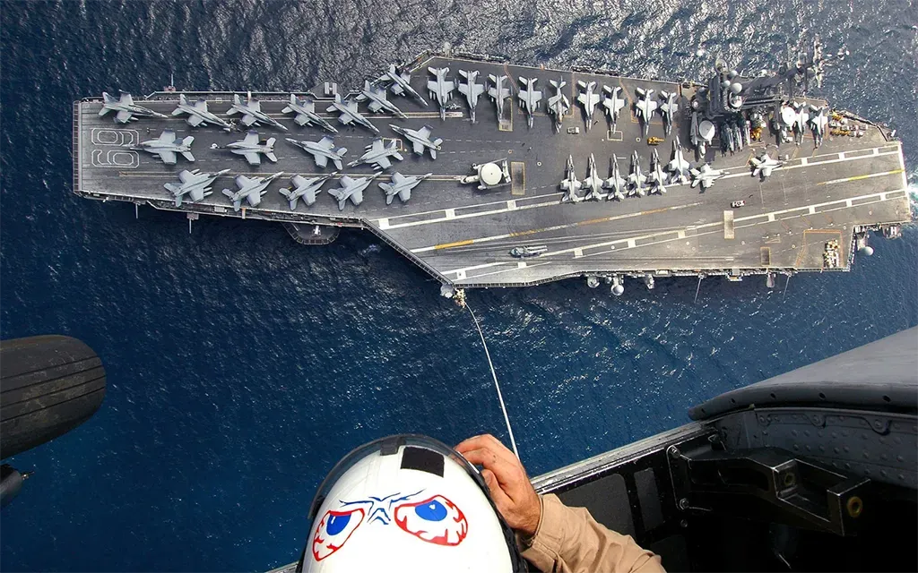 Aerial view of an aircraft carrier from a pilot's cockpit