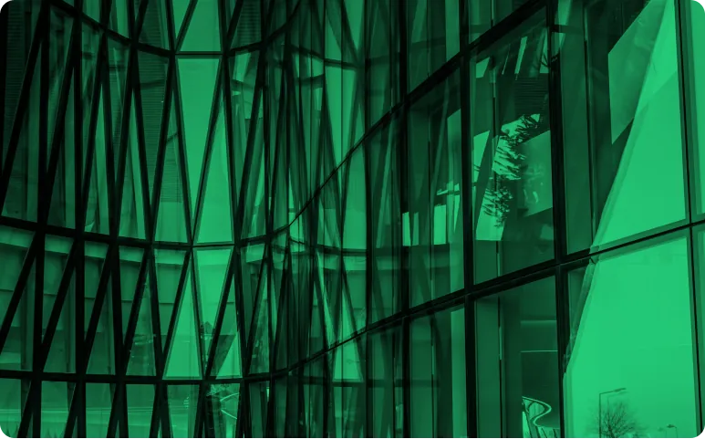 Green-tinted view of a glass building facade