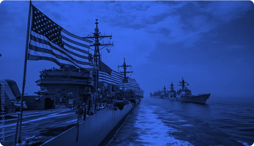 U.S. Navy ships at sea with an American flag, tinted blue